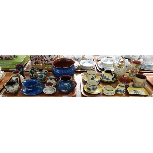 388 - Two trays of Torquay and Devon ware items to include: motto ware two handled pot, jugs, similar jard... 