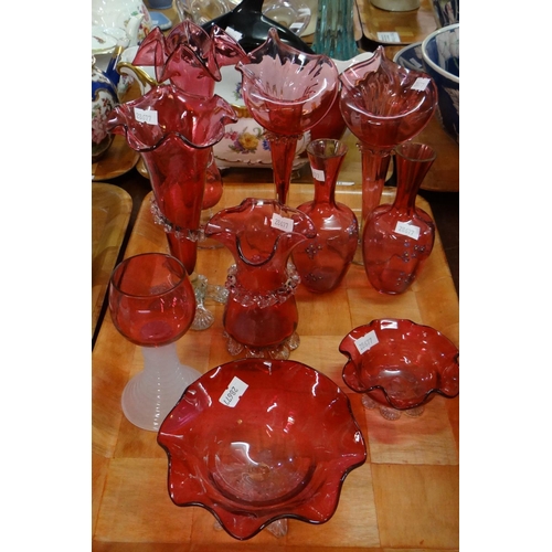 411 - Tray of cranberry glass items to include: trumpet vases, trinket bowls, liqueur glass etc. 
(B.P. 21... 