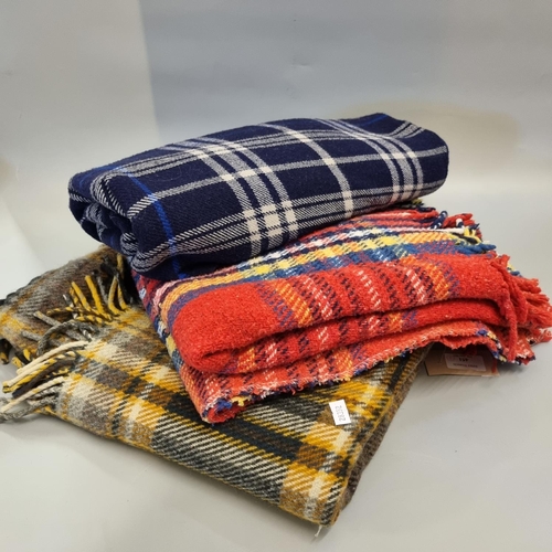 451 - Three vintage check blankets in different colours, two with fringe. 
(B.P. 21% + VAT)