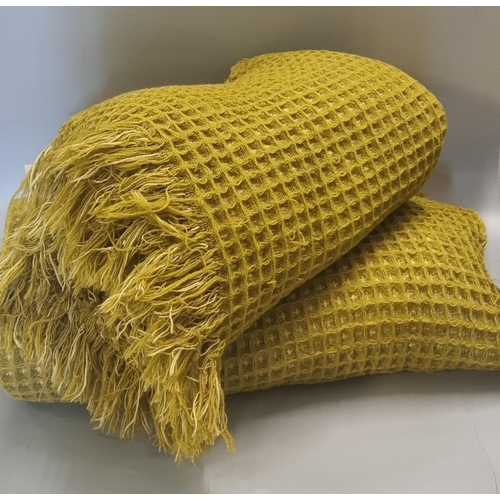 468 - Two vintage woollen honeycomb blankets with fringed edges. 
(B.P. 21% + VAT)