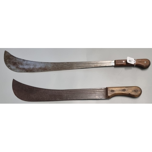 83 - Two vintage Parang type jungle knives or Machetes with wooden grips and fullered curved single edged... 