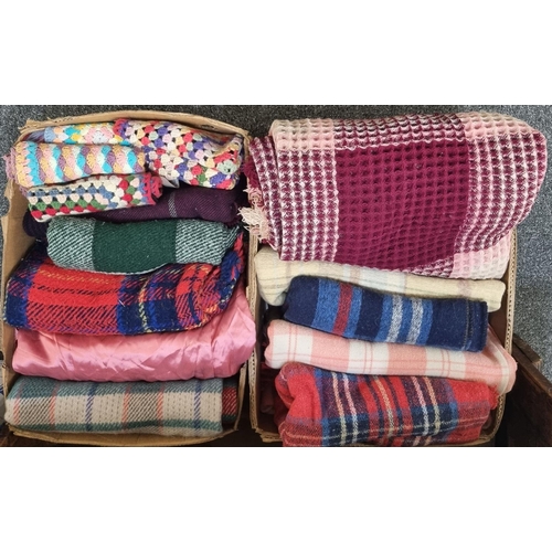 159 - Two boxes containing vintage textiles to include: a honeycomb check design blanket, a pink and cream... 