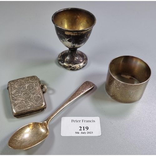 219 - Bag of silver to include: napkin ring, single teaspoon, egg cup and vesta case.  3.2 troy oz approx.... 