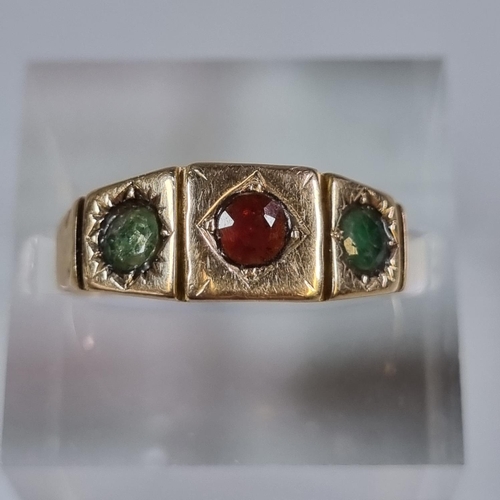 229 - 18ct gold three stone green and red ring.  3.6g approx.  Size L.  (B.P. 21% + VAT)