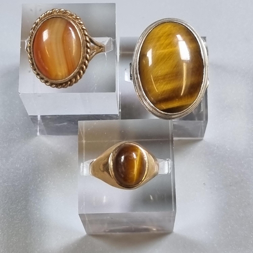 250 - 9ct gold tiger's eye dress ring together with a 9ct gold agate ring and a silver and tiger's eye rin... 