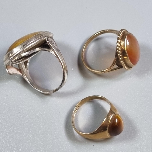 250 - 9ct gold tiger's eye dress ring together with a 9ct gold agate ring and a silver and tiger's eye rin... 