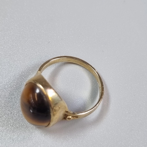 251 - 9ct gold tiger's eye dress ring.  4.9g approx.  Size S.  Together with a pair of matching 9ct gold p... 