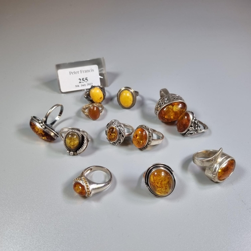 255 - Bag of continental silver and amber dress rings.  (B.P. 21% + VAT)