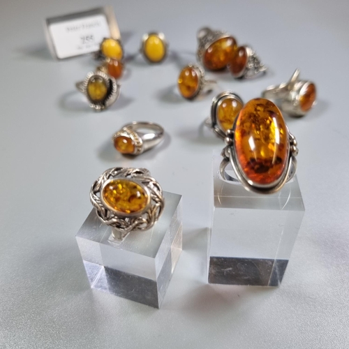 255 - Bag of continental silver and amber dress rings.  (B.P. 21% + VAT)