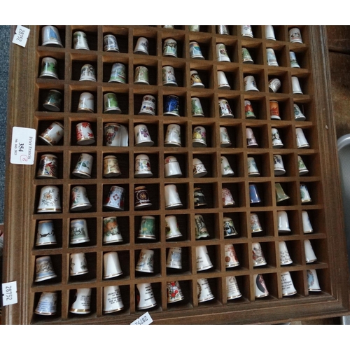 354 - Large collection of mostly china thimbles in two wooden cases, individual packaging and loose, to in... 