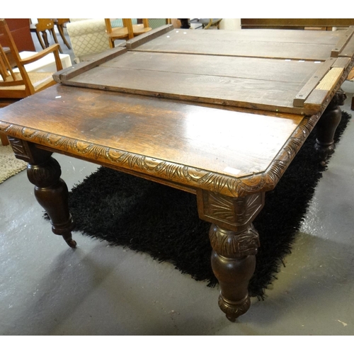 477 - Late Victorian carved oak extending dining table with two additional leaves.  (B.P. 21% + VAT)