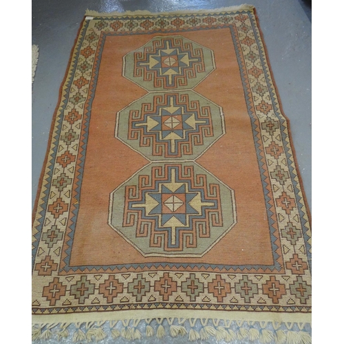 517 - Turkish Kilim type carpet on a salmon ground with geometric medallion panels.  (B.P. 21% + VAT)