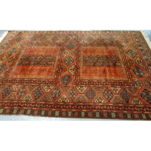 519 - Vintage Middle Eastern red ground carpet with multi geometric panels and foliate decoration.  (B.P. ... 