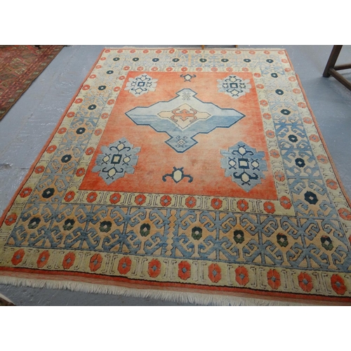 521 - Turkish style salmon ground carpet with central tarantula medallion and foliate designs to the borde... 