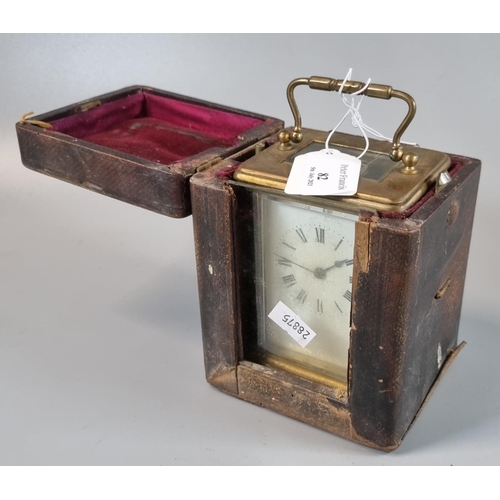 82 - Late Victorian brass carriage clock with enamel face and Roman numerals in original leather carrying... 