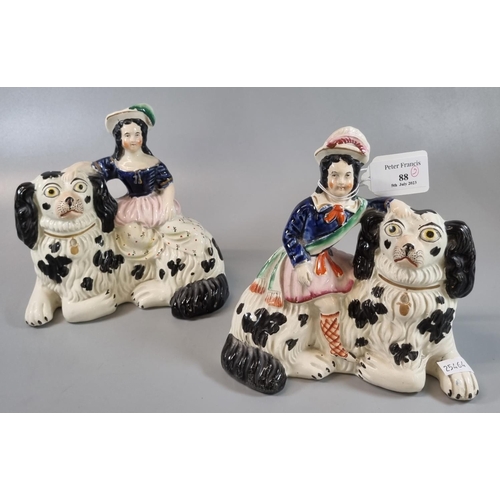 88 - Pair of 19th Century Staffordshire figures sitting on large Spaniel dogs. (2)
(B.P. 21% + VAT)