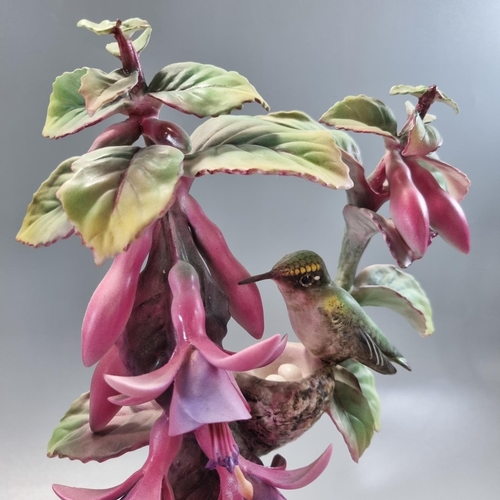 148 - Pair of Royal Worcester ruby throated humming bird figurines on composition Art Deco style stepped b... 