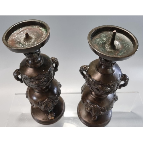 177 - Pair of Japanese bronze tripod candlesticks with panels of birds in branches and bull's head at the ... 