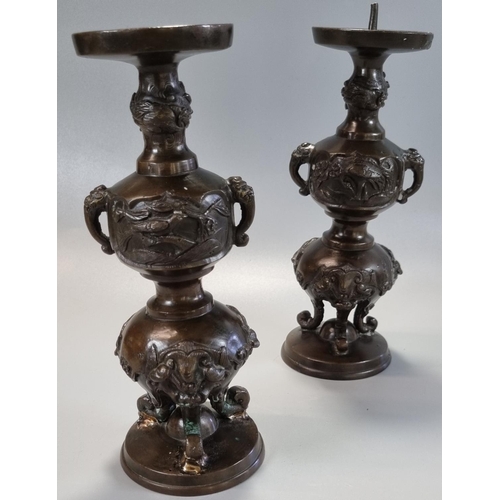 177 - Pair of Japanese bronze tripod candlesticks with panels of birds in branches and bull's head at the ... 