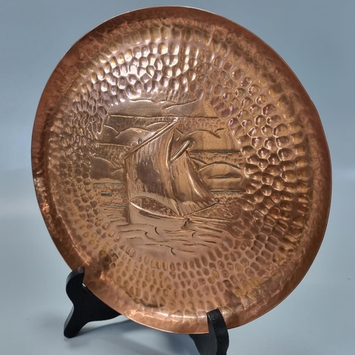 180 - Three Arts & Crafts repoussé decorated Newlyn copper items to include: fish pen tray 26x7cm approx, ... 