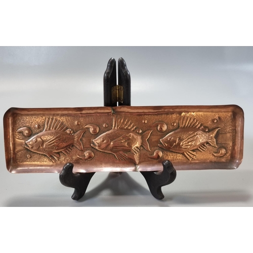 180 - Three Arts & Crafts repoussé decorated Newlyn copper items to include: fish pen tray 26x7cm approx, ... 