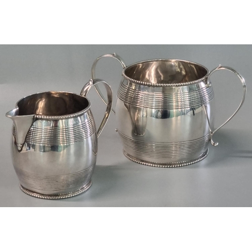 219 - Silver two piece Victorian part tea service, to include: two handled sucrier and cream/milk jug, bot... 