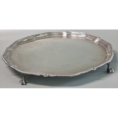 223 - 20th century silver pie crust salver standing on four ball and claw feet, by Harrison Brothers & How... 