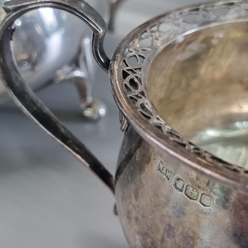 226 - Three piece silver tea service, by Walker & Hall Sheffield, having pierced rim mounts, two with the ... 