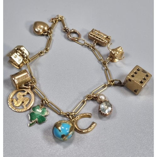 260 - 9ct gold charm bracelet with assorted charms including: dice, globe, heart, cottage, bus, bulls's he... 