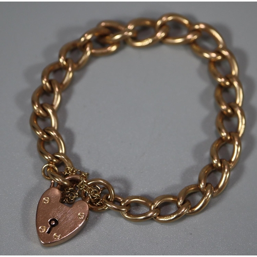 261 - 9ct gold curblink bracelet with heart padlock.  32.5g approx.  (B.P. 21% + VAT)