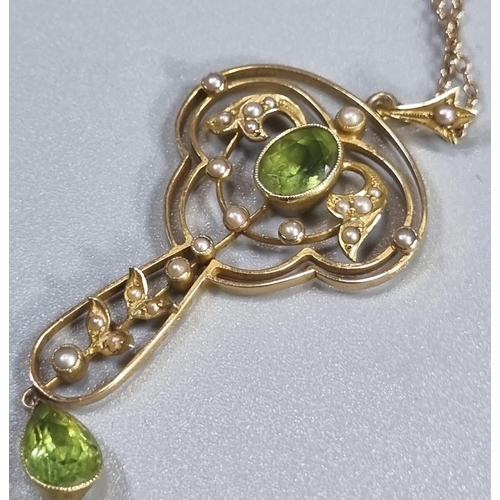 263 - 15ct gold Art Nouveau design peridot and Seed Pearl pendant on a 9ct gold chain.  6.4g approx.  (B.P... 