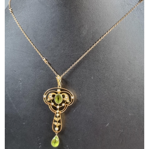 263 - 15ct gold Art Nouveau design peridot and Seed Pearl pendant on a 9ct gold chain.  6.4g approx.  (B.P... 