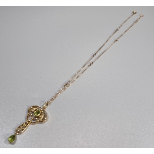 263 - 15ct gold Art Nouveau design peridot and Seed Pearl pendant on a 9ct gold chain.  6.4g approx.  (B.P... 