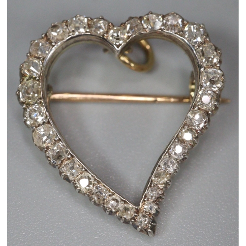 273 - Gold and diamond heart shaped brooch, set with approximately 30 diamonds, appearing unmarked.  2cm l... 