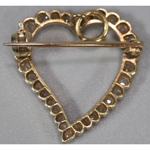 273 - Gold and diamond heart shaped brooch, set with approximately 30 diamonds, appearing unmarked.  2cm l... 