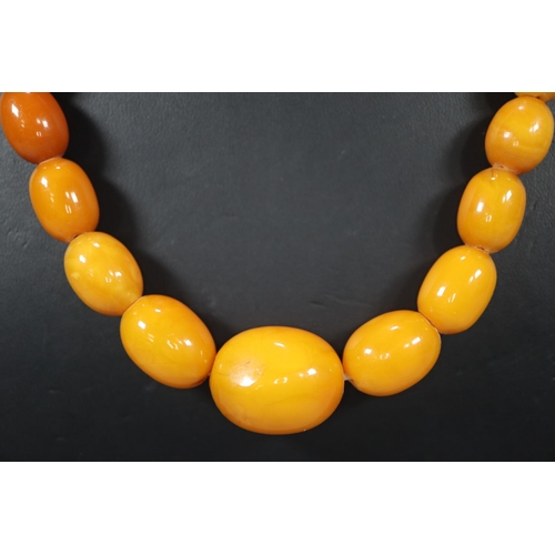 275 - Amber Butterscotch necklace.  59g approx.  The largest bead  2.5cm long approx.  (B.P. 21% + VAT)