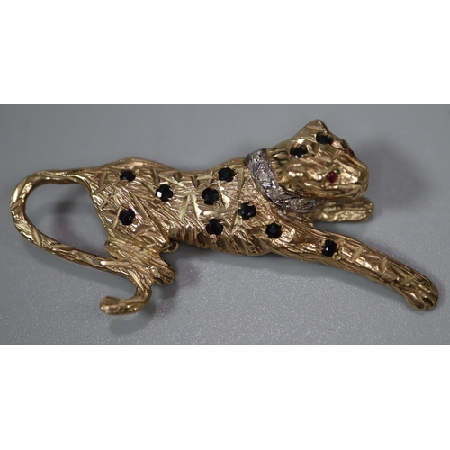 276 - 9ct gold leopard brooch decorated with naturalistic features, diamonds and rubies for eyes.  5cm lon... 