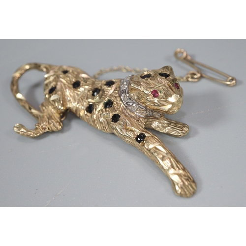 276 - 9ct gold leopard brooch decorated with naturalistic features, diamonds and rubies for eyes.  5cm lon... 