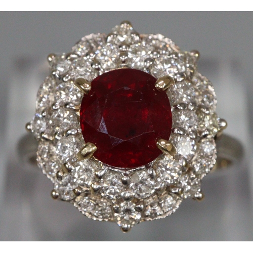 291 - 18ct white gold ruby and diamond ring, the central faceted ruby surrounded by tiny diamonds.  Size R... 