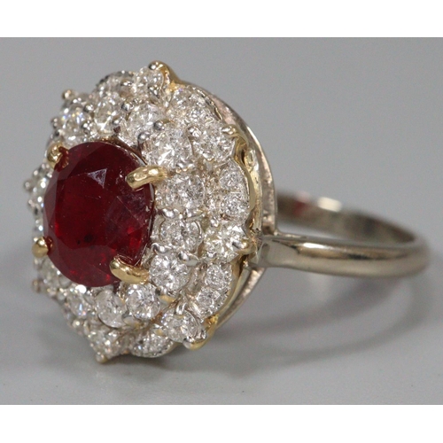 291 - 18ct white gold ruby and diamond ring, the central faceted ruby surrounded by tiny diamonds.  Size R... 