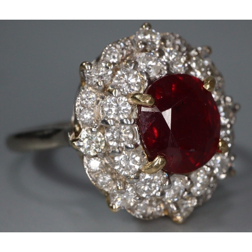 291 - 18ct white gold ruby and diamond ring, the central faceted ruby surrounded by tiny diamonds.  Size R... 