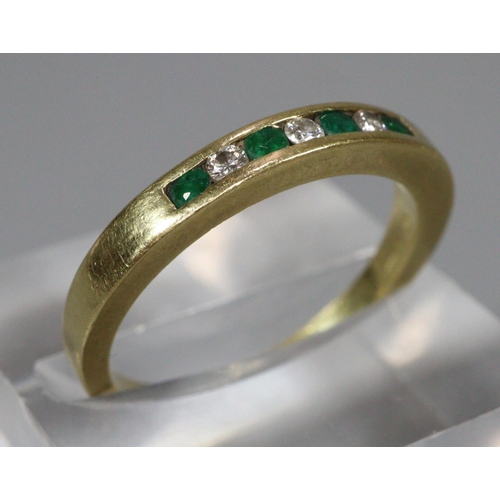 302 - 18ct gold diamond and emerald seven stone hoop ring. Ring size N, 3.6g approx.
(B.P. 21% + VAT)