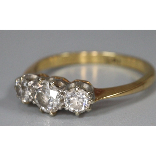 312 - 18ct gold three stone diamond ring.  Ring size N1/2.  3.1g approx.   (B.P. 21% + VAT)