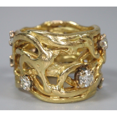 314 - 18ct gold wide modernist and pierced design ring with a collection of nine diamonds.  13.3g approx. ... 