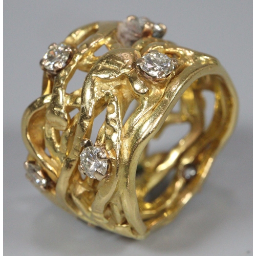 314 - 18ct gold wide modernist and pierced design ring with a collection of nine diamonds.  13.3g approx. ... 