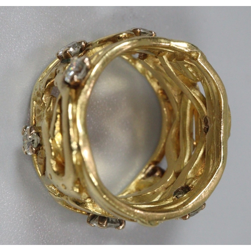 314 - 18ct gold wide modernist and pierced design ring with a collection of nine diamonds.  13.3g approx. ... 