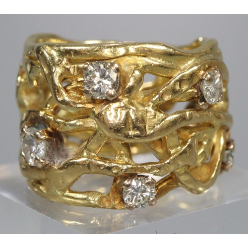 314 - 18ct gold wide modernist and pierced design ring with a collection of nine diamonds.  13.3g approx. ... 