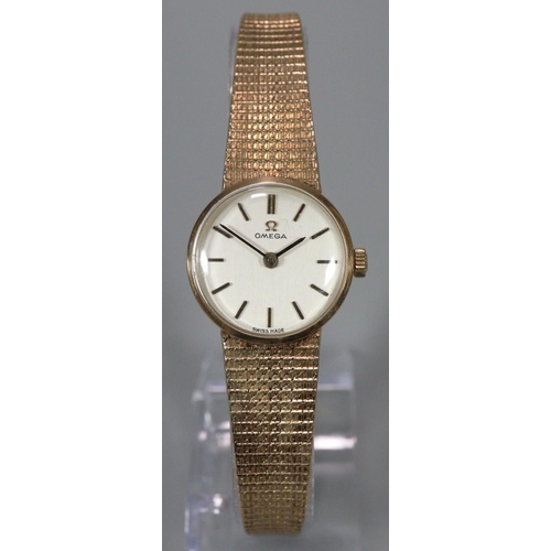 327 - Omega 9ct gold ladies bracelet mechanical wristwatch having satin face with Baton numerals and mesh ... 