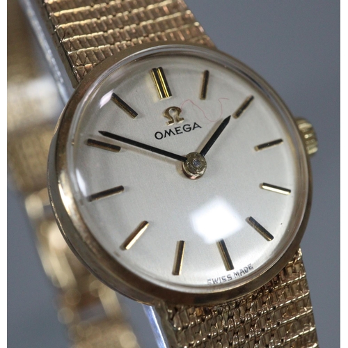 327 - Omega 9ct gold ladies bracelet mechanical wristwatch having satin face with Baton numerals and mesh ... 