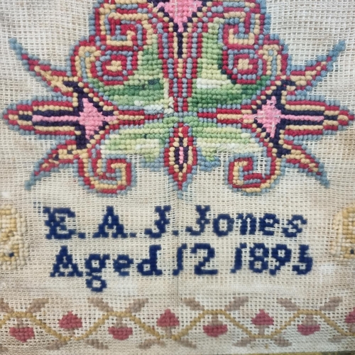 349 - Late Victorian child's sampler, E. A. J. Jones, Aged 12, dated 1895, overall decorated with flowers,... 